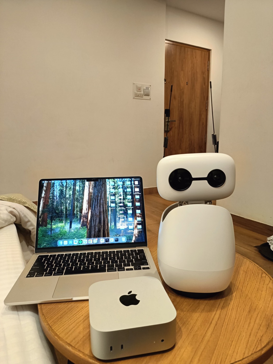 My desk, with a small robot keeping the laptop company